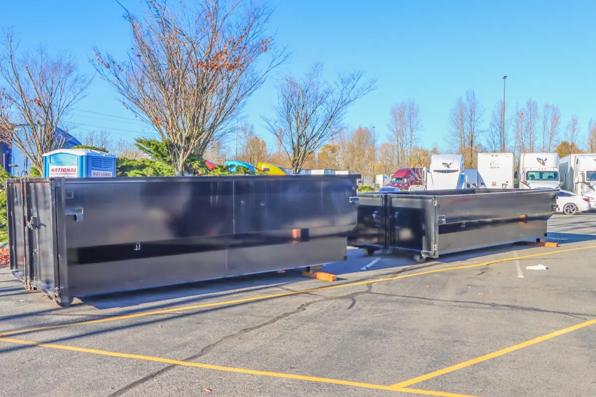 Professional dumpster rental service with roll-off container on residential driveway in Shamokin